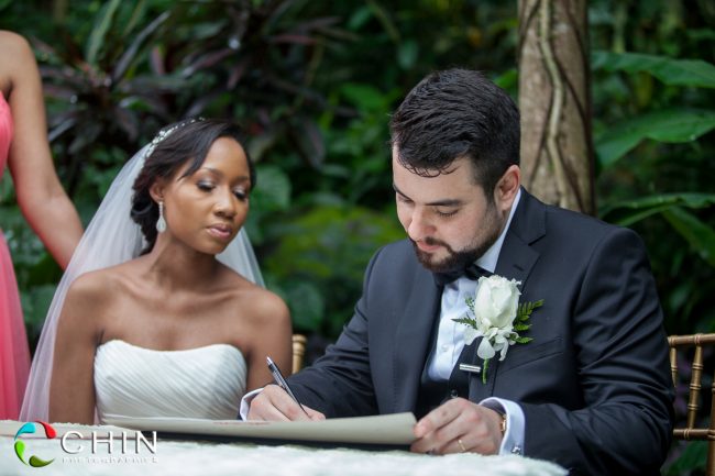 Groom signs the register